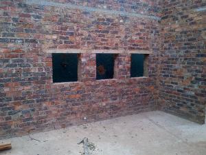 Windows between lower and upper kitchen cupboards.