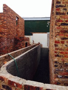 Part of this space - between the cottage and the double retaining walls - will be made into a garden storeroom.