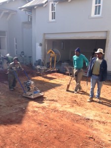 Compressing the soil in front of the garage.