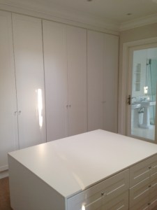 Dressing room with glass door to bathroom.