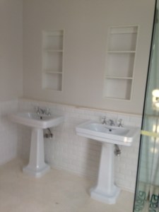 Basins waiting for mirrored cupboards.