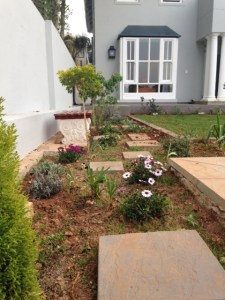 The bed along the east boundary wall.